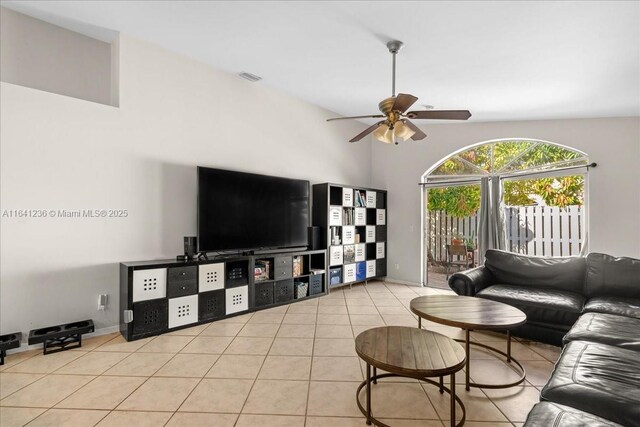 tiled living room featuring ceiling fan and high vaulted ceiling