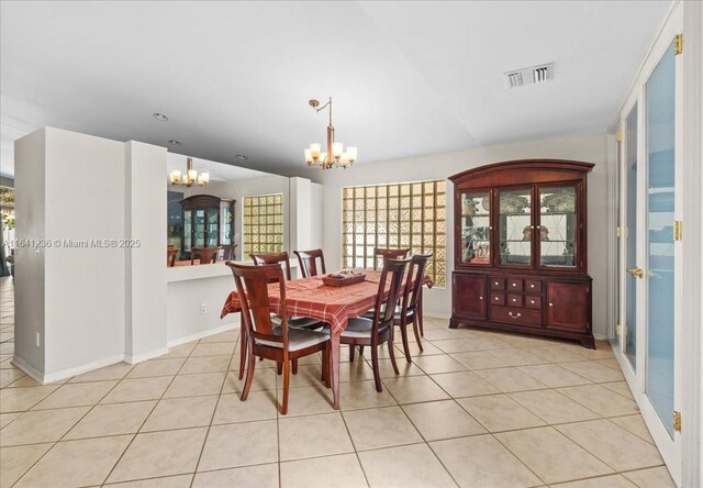 dining room featuring light tile patterned floors and a chandelier