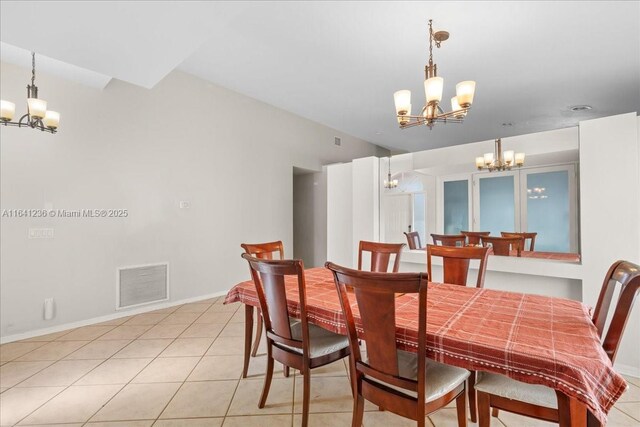 tiled dining space with a notable chandelier