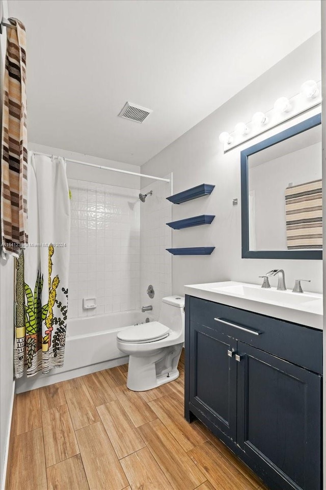 full bathroom with vanity, wood-type flooring, toilet, and shower / bath combo