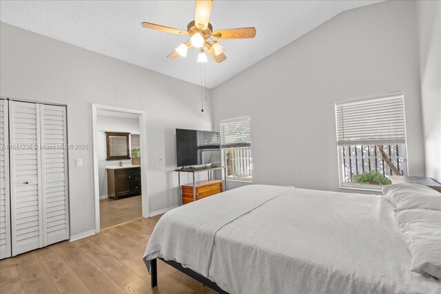 bedroom featuring ceiling fan, high vaulted ceiling, and light hardwood / wood-style flooring