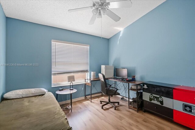 office area with ceiling fan, hardwood / wood-style flooring, and a textured ceiling