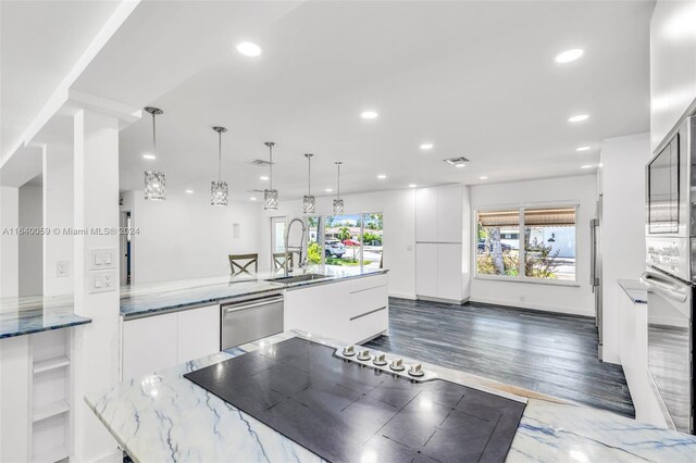 kitchen featuring appliances with stainless steel finishes, dark hardwood / wood-style floors, sink, and white cabinets