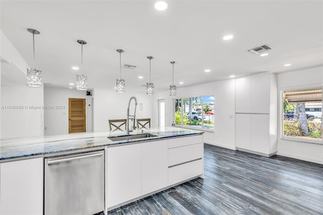 kitchen featuring sink, white cabinets, decorative light fixtures, and dishwasher