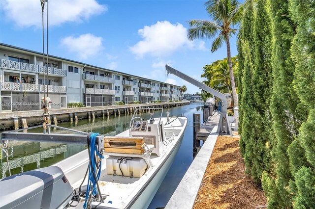 view of dock featuring a water view and a balcony