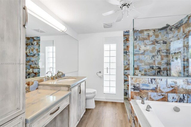 bathroom with ceiling fan, wood-type flooring, vanity, and plenty of natural light