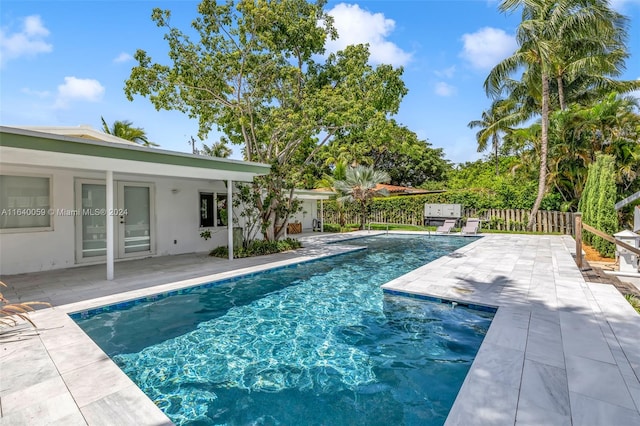 view of swimming pool featuring a patio area