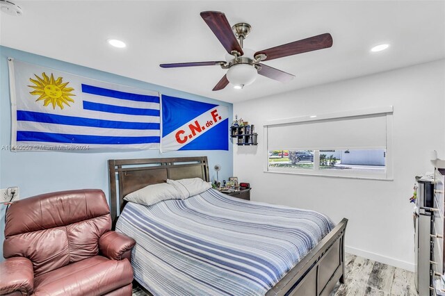 bedroom with ceiling fan and light hardwood / wood-style floors