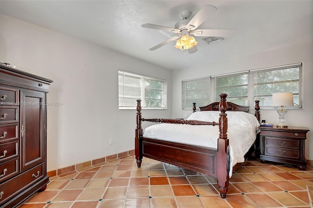 tiled bedroom with ceiling fan