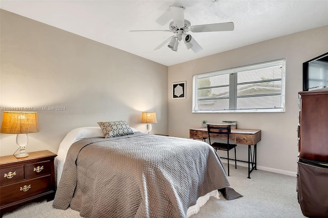 bedroom with ceiling fan, light colored carpet, and multiple windows