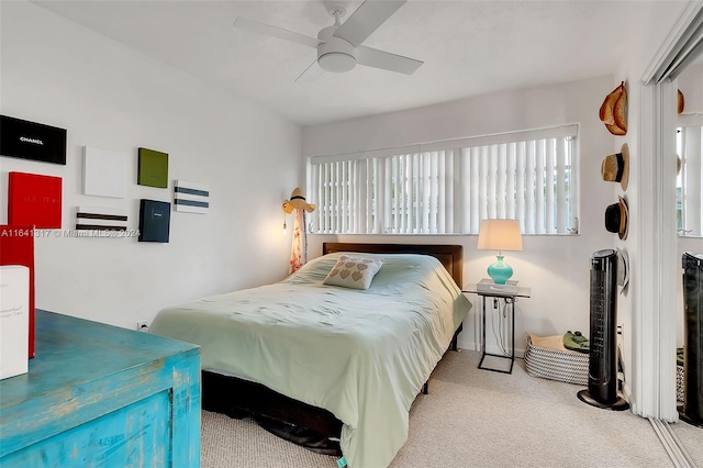 bedroom with ceiling fan and light colored carpet