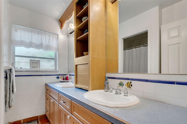 bathroom featuring vanity and tile walls