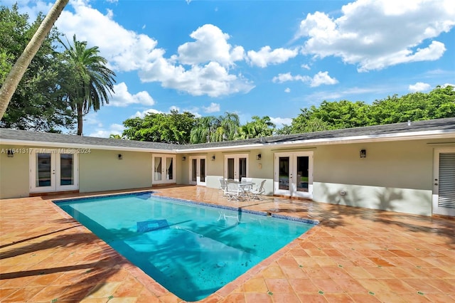 view of pool with a patio and french doors