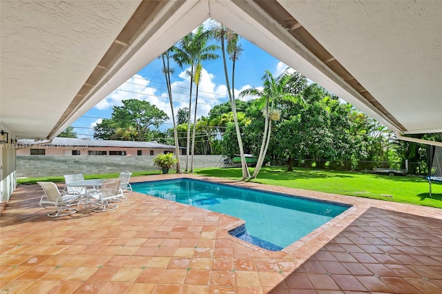 view of pool featuring a yard and a patio area