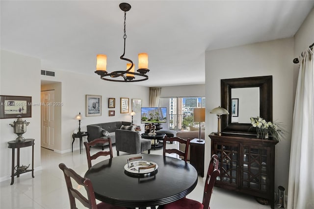 dining area featuring an inviting chandelier and light tile patterned floors