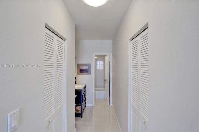 hall featuring light tile patterned floors