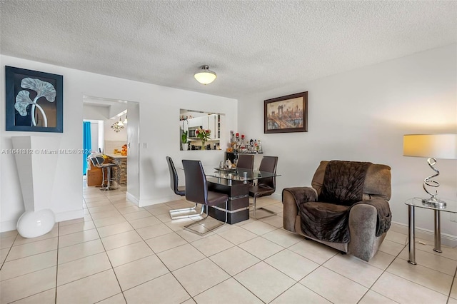 living room with light tile patterned flooring and a textured ceiling