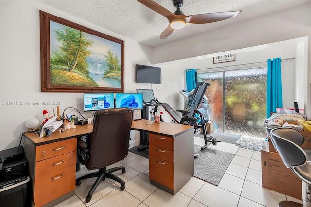 tiled home office with a textured ceiling and ceiling fan