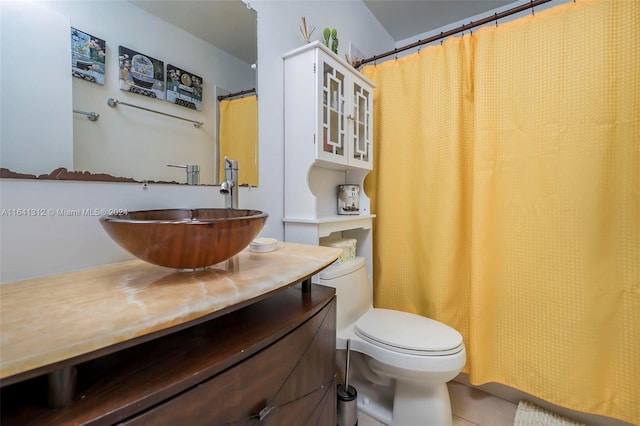 bathroom featuring vanity, toilet, and tile patterned flooring