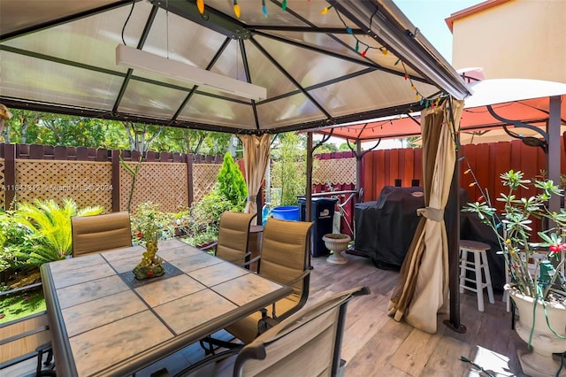 deck featuring grilling area and a gazebo