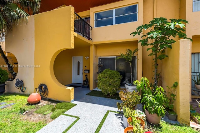 doorway to property featuring a balcony and a patio