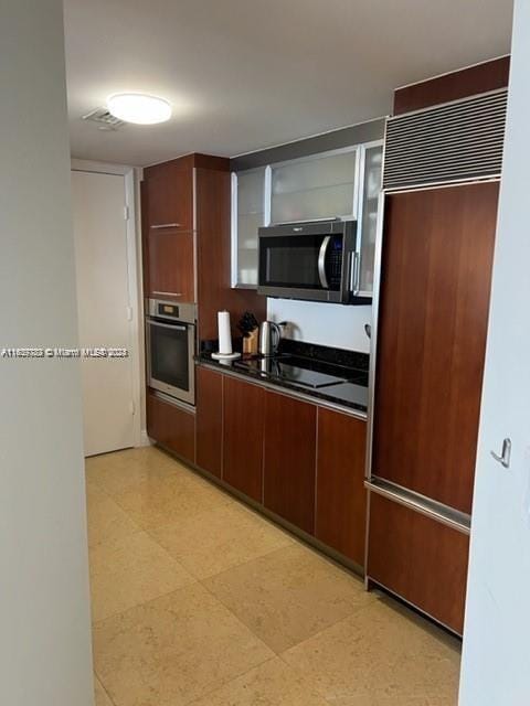 kitchen with light tile patterned floors and stainless steel appliances