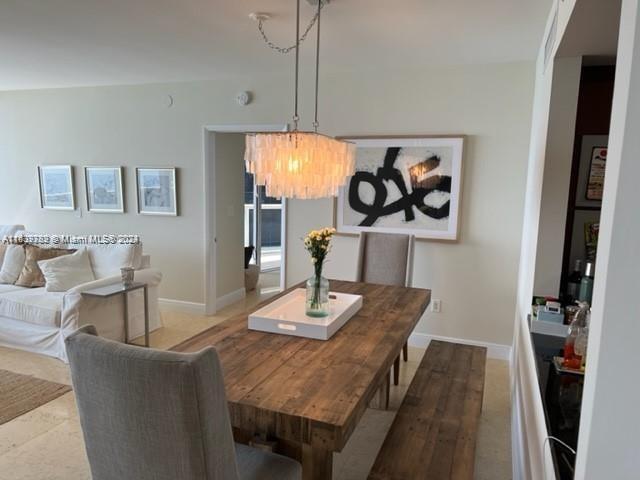 dining space with a notable chandelier and hardwood / wood-style flooring