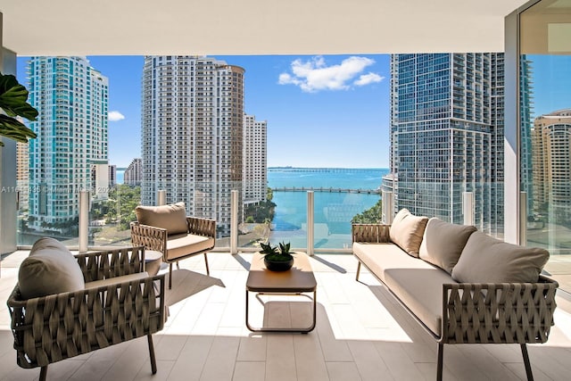 balcony featuring a water view and an outdoor hangout area