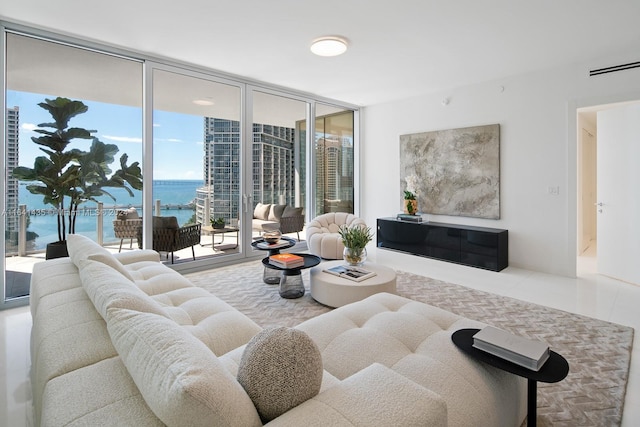 living room with tile patterned floors, floor to ceiling windows, and a water view