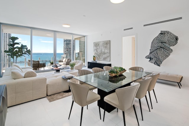 dining room featuring expansive windows and a water view