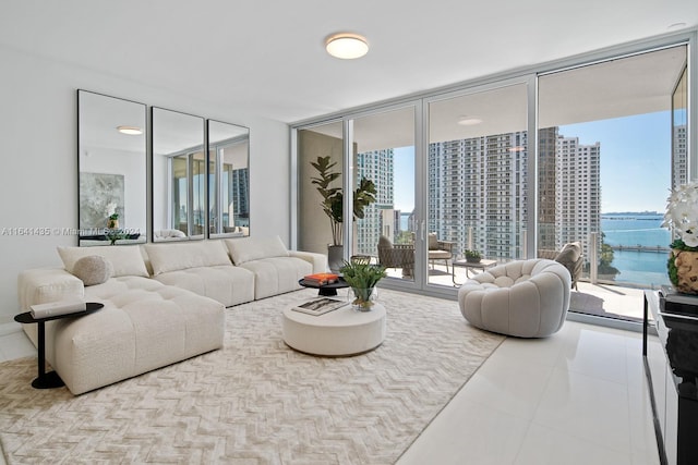 tiled living room with a water view and a wall of windows