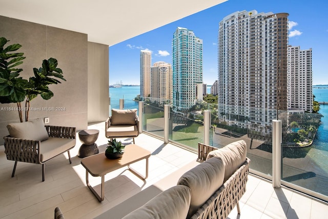 balcony with an outdoor hangout area and a water view