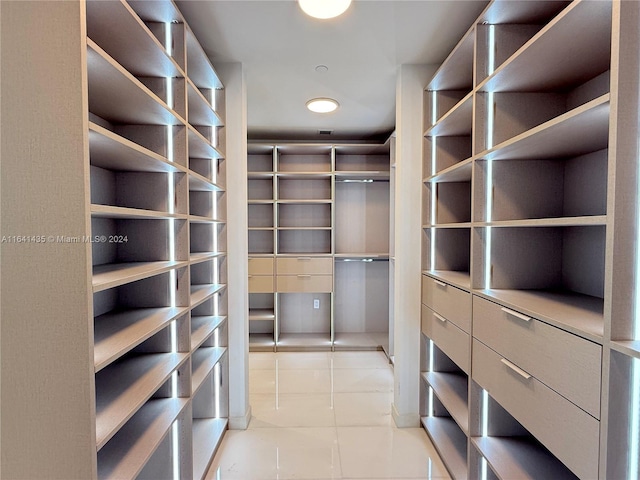 spacious closet featuring light tile patterned floors