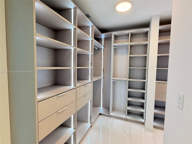 spacious closet featuring light tile patterned floors