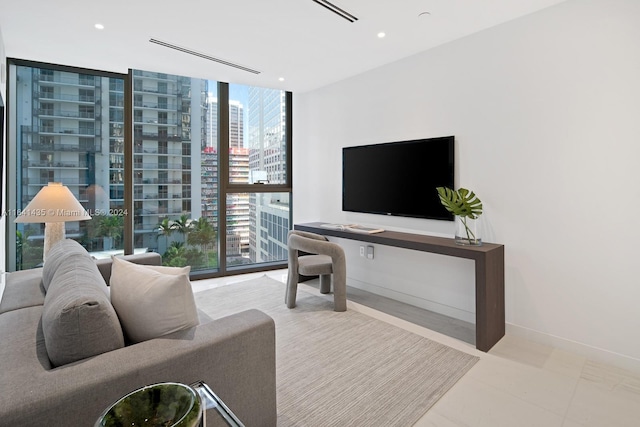 living room with expansive windows and light tile patterned flooring