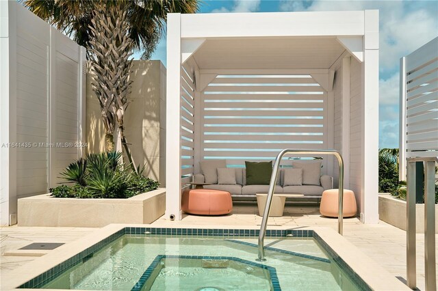 view of pool featuring a patio area and an in ground hot tub