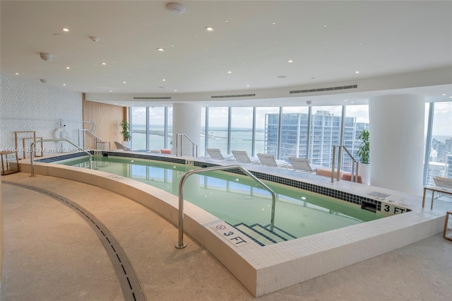 view of swimming pool with a jacuzzi