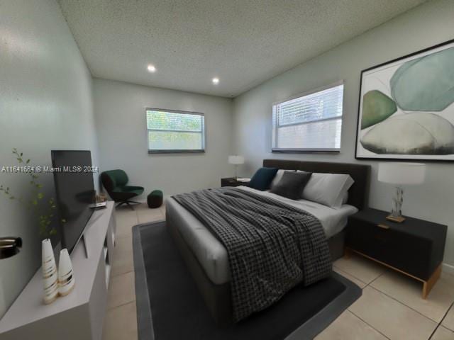 bedroom featuring a textured ceiling and light tile patterned floors