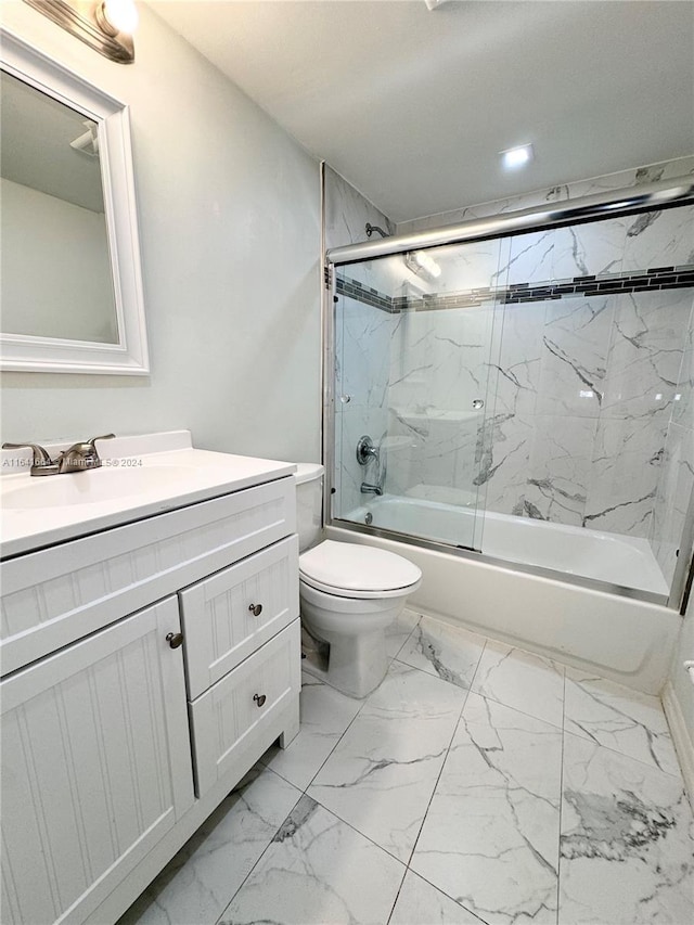 full bathroom with tile patterned floors, vanity, toilet, and shower / bath combination with glass door