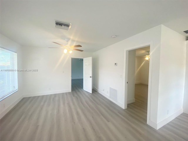 empty room with light hardwood / wood-style flooring