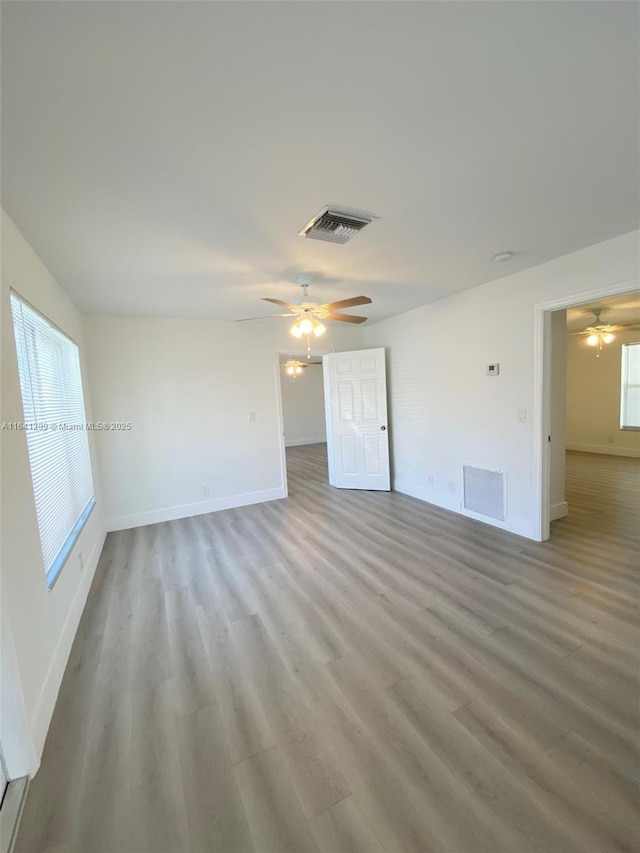 1005 NE 2nd St, Hallandale Beach, FL 33009 - spare room featuring light wood-type flooring, a ceiling fan, and baseboards