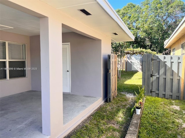 1005 NE 2nd St, Hallandale Beach, FL 33009 - exterior space with stucco siding, a gate, fence, and a patio area
