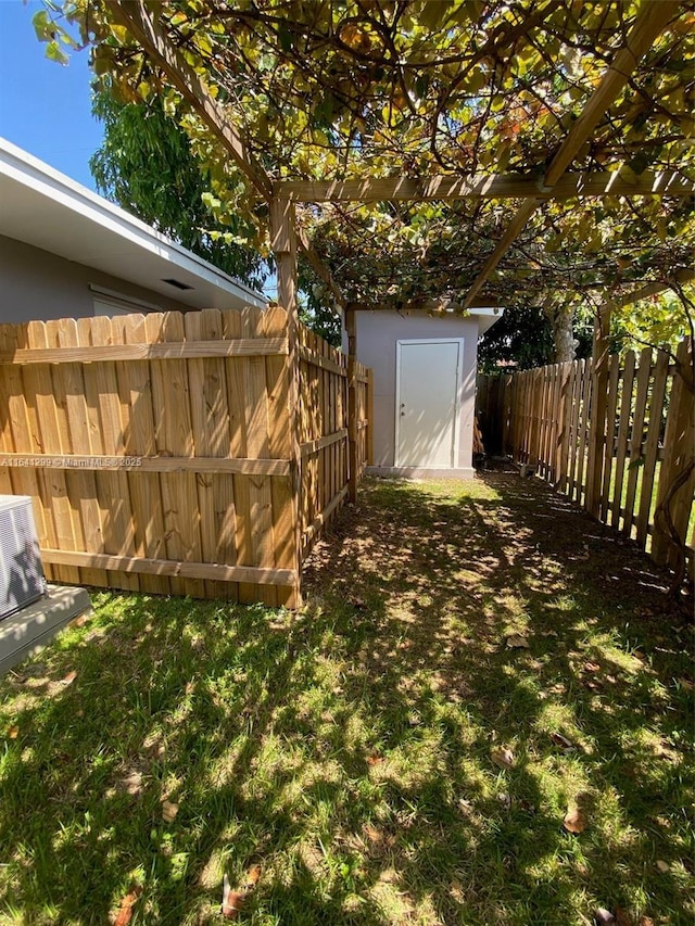 1005 NE 2nd St, Hallandale Beach, FL 33009 - view of yard with a fenced backyard, an outdoor structure, and a shed