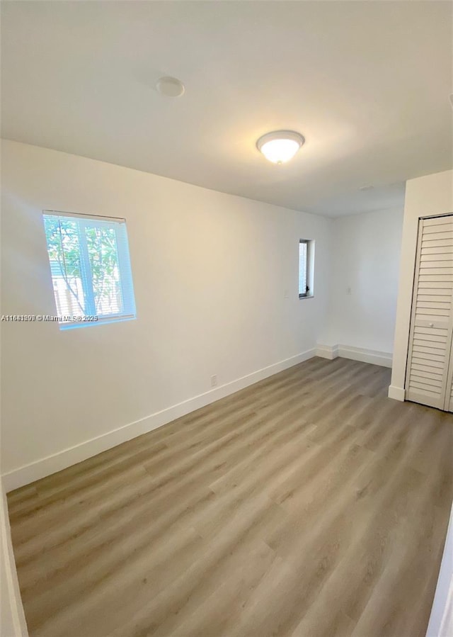1005 NE 2nd St, Hallandale Beach, FL 33009 - interior space with baseboards, light wood-style floors, and multiple windows