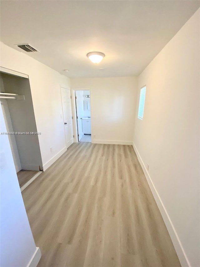1005 NE 2nd St, Hallandale Beach, FL 33009 - empty room with baseboards, visible vents, and light wood-style flooring