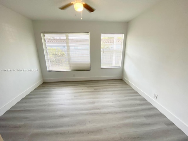 spare room with ceiling fan and a healthy amount of sunlight