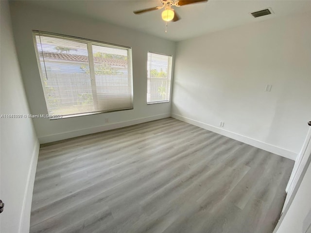 unfurnished room featuring light wood-type flooring and ceiling fan