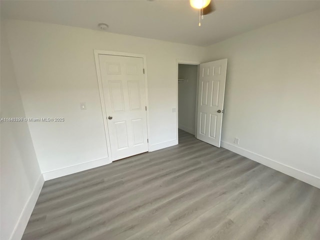 unfurnished bedroom featuring wood-type flooring and a closet