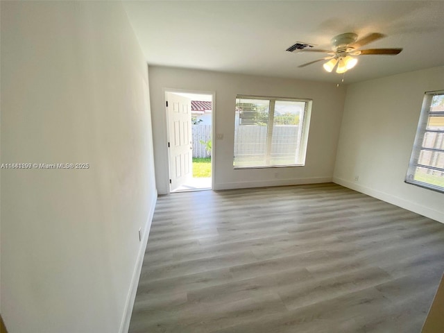 1005 NE 2nd St, Hallandale Beach, FL 33009 - unfurnished room featuring baseboards, wood finished floors, visible vents, and a ceiling fan
