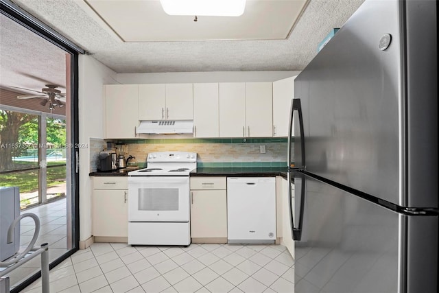 kitchen with a textured ceiling, white appliances, ceiling fan, backsplash, and white cabinetry